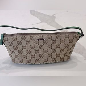 Classic Gucci design wristlet with green leather accent trim.